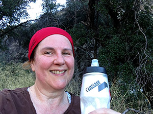 Laurie enjoys refreshing water at the top of the hiking trail.