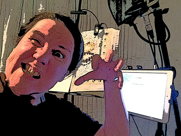Laurie making a scary face in her sound studio and holding her hand like a claw!